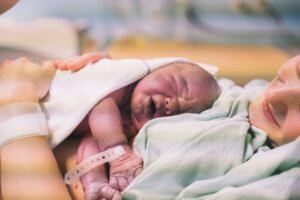 امراة تحمل طفلها حديث الولادة وتتسائل متى يرى الطفل أمه بوضوح